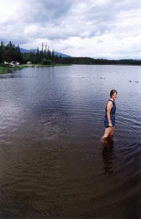 Alison wading in a lake in Alaska