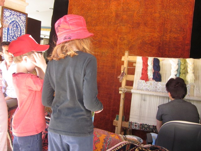 woman tying rug