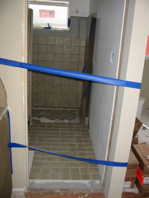 tile on the bathroom floor, blue tape