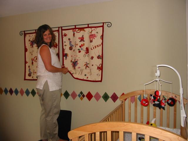 Alison hanging clown fabric on the wall